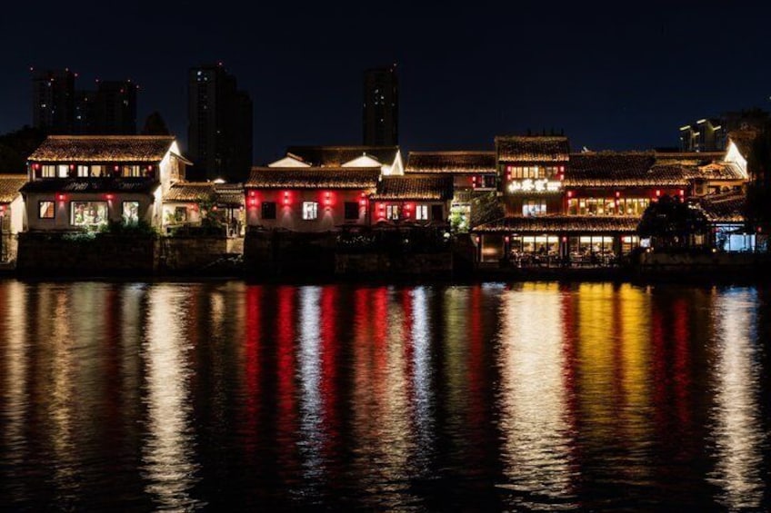 A night view of traditional buildings with reflections on the water. 2
