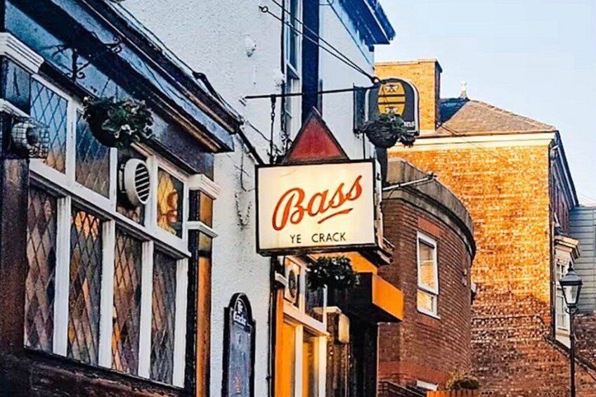A building with a sign that reads 'Bass Ye Crack.' 1