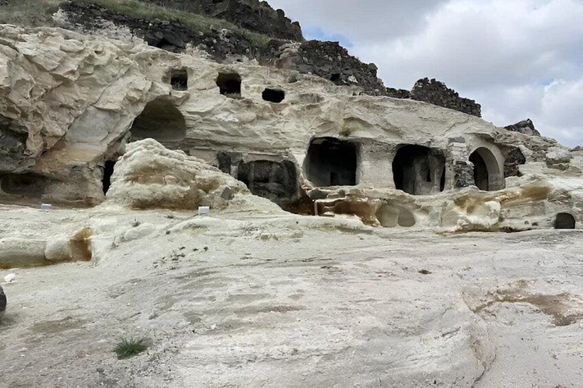 A rocky landscape with multiple cave entrances and a flat foreground. 4