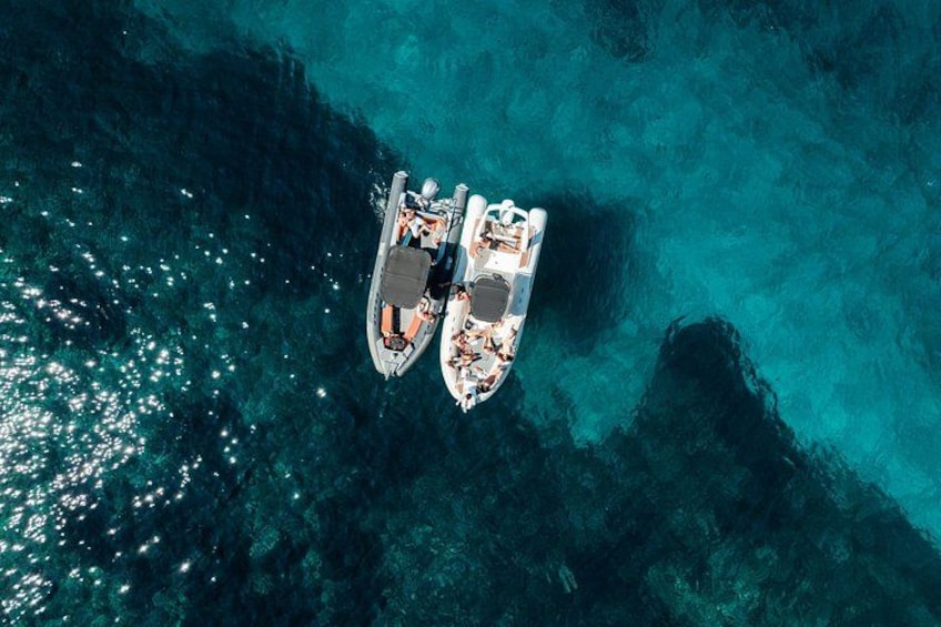 Two boats anchored in clear turquoise water. 1