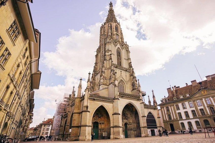 A historic cathedral with intricate architecture, a cobblestone street, and surrounding buildings. 5