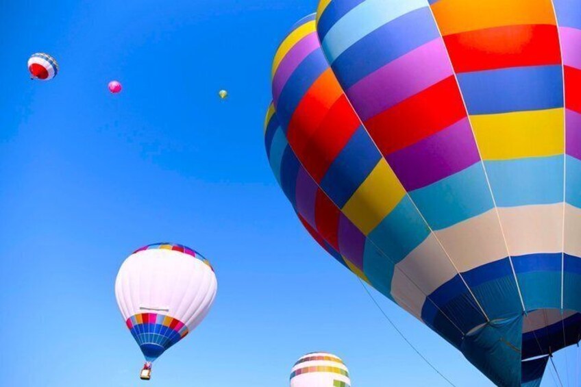 Multiple hot air balloons in the sky. 5