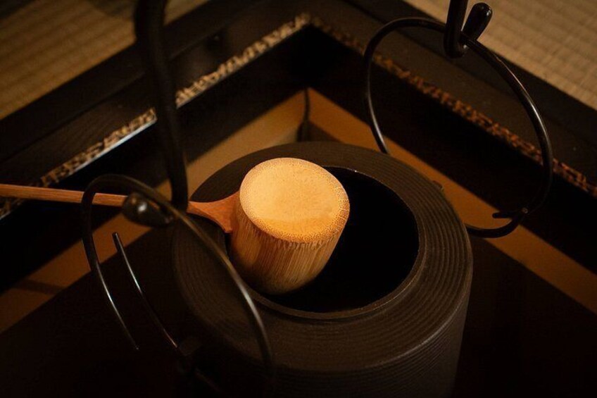 A wooden bowl on a black chair with a woven texture. 3