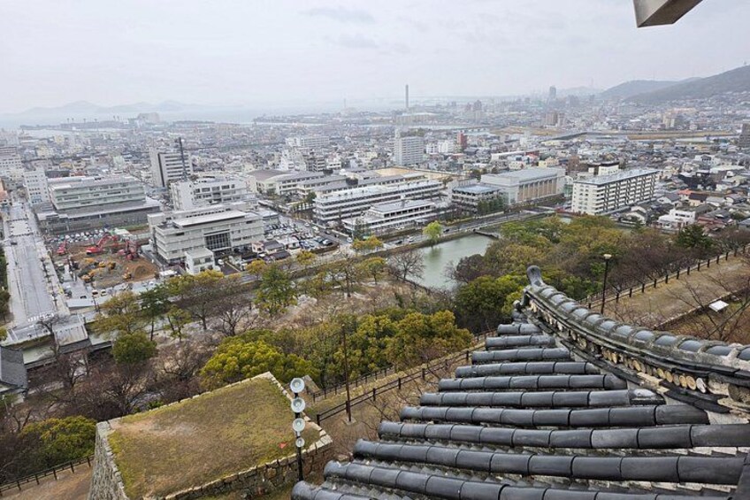 A cityscape with modern buildings, a river, and traditional Japanese architecture. 5