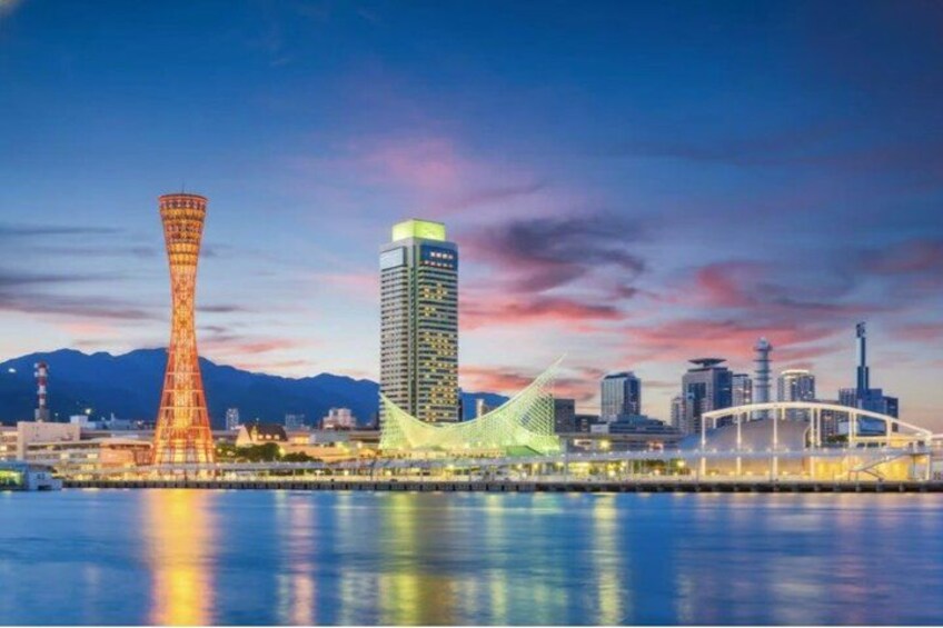 A city skyline with a tall tower, a modern building, and a bridge. 3