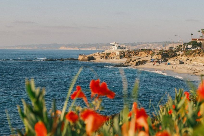 A coastal landscape with a beach, ocean, and cliffs. 5