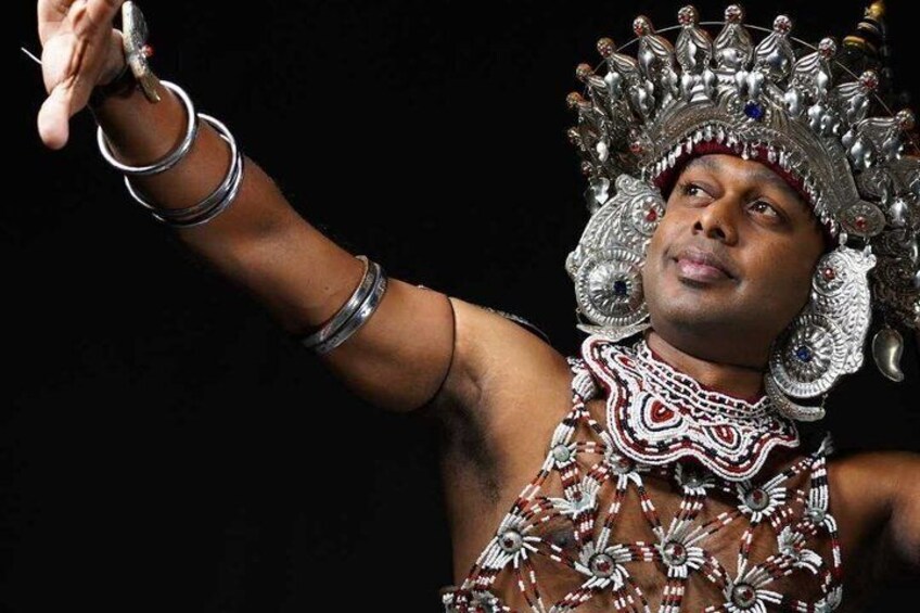 A person in traditional attire with a headdress and jewelry. 2