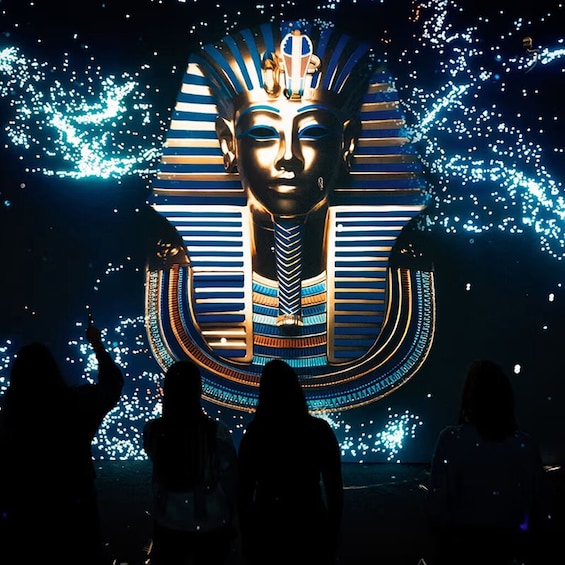 A large illuminated sphinx with hieroglyphics, set against a dark background with scattered lights. 4