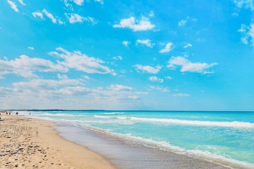 A beach with clear skies and calm waves. 2