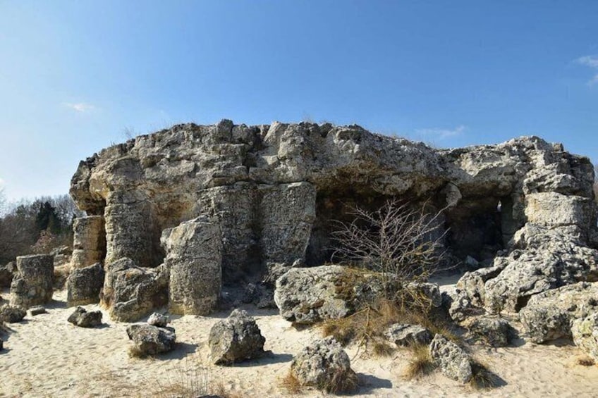 Ancient ruins with a large cave-like structure. 5
