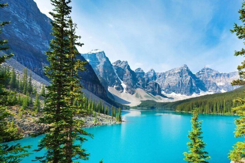 A mountain lake surrounded by forest and rugged peaks. 2