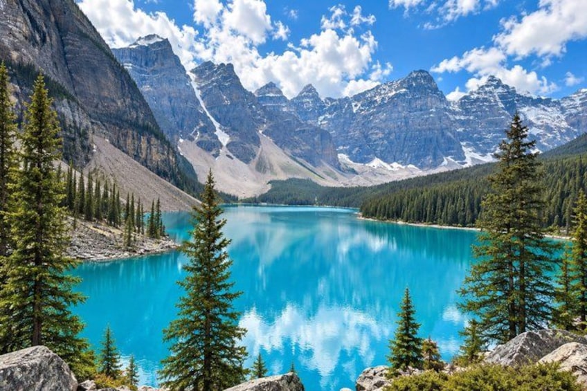 A turquoise lake surrounded by mountains and coniferous trees. 1