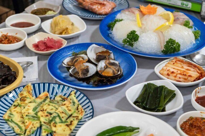 A variety of Korean dishes including seafood, rice, and vegetables. 4