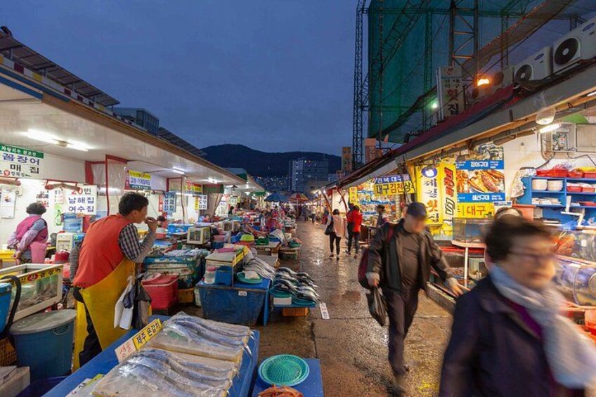 A bustling night market with vendors and shoppers. 2