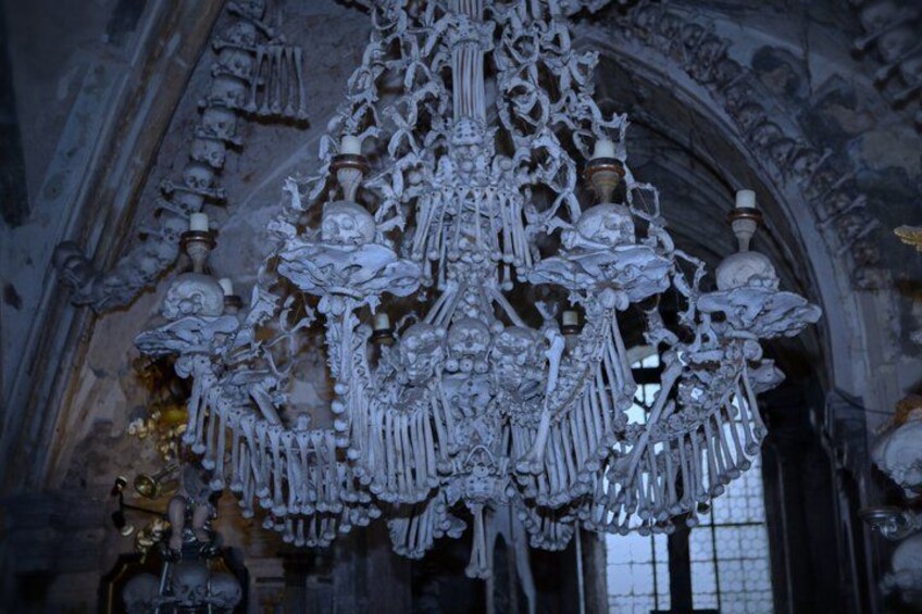 An ornate chandelier with intricate designs and multiple light fixtures. 5