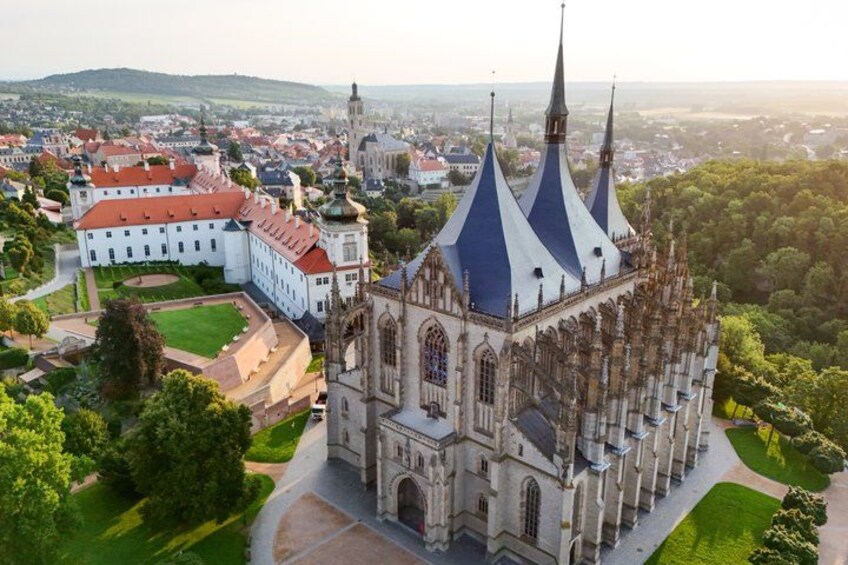 A historic church with a distinctive blue roof and a large courtyard. 1