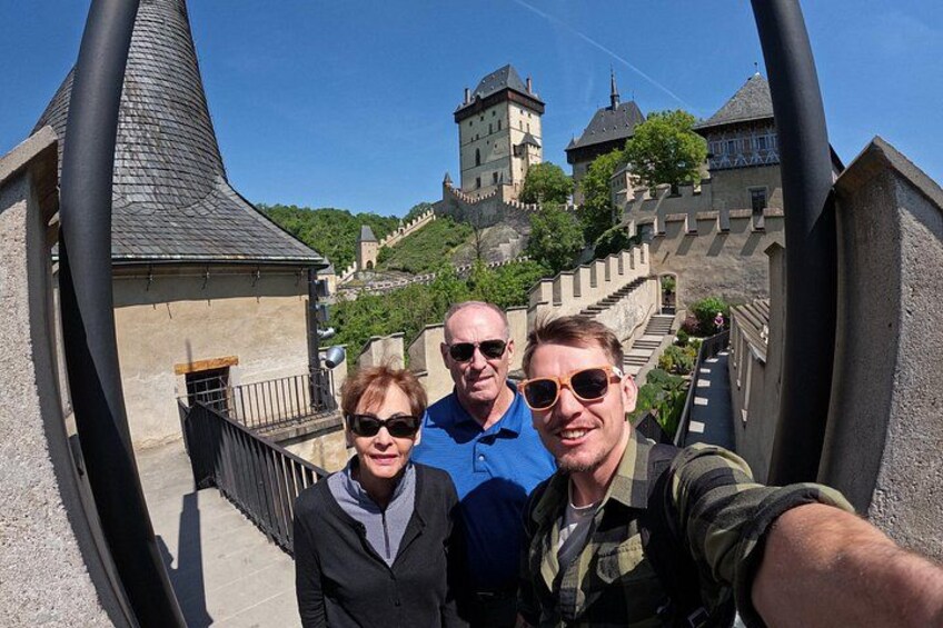A selfie with three people, a castle, and a steep staircase. 5