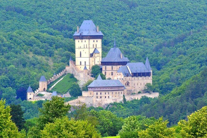 A castle on a hill surrounded by lush greenery. 4