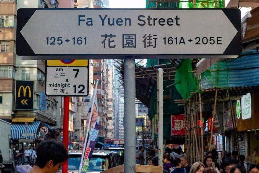 A street sign for Fa Yuen Street with directional arrows and a McDonald's sign nearby. 1