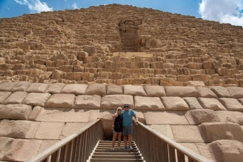 A large stone structure with a staircase leading up to it. 2