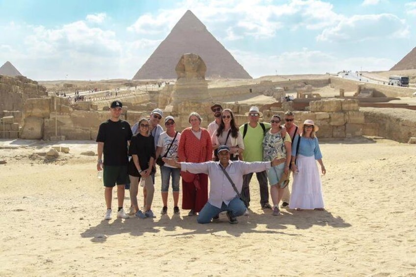 A group of people posing in front of the Great Pyramid of Giza. 3
