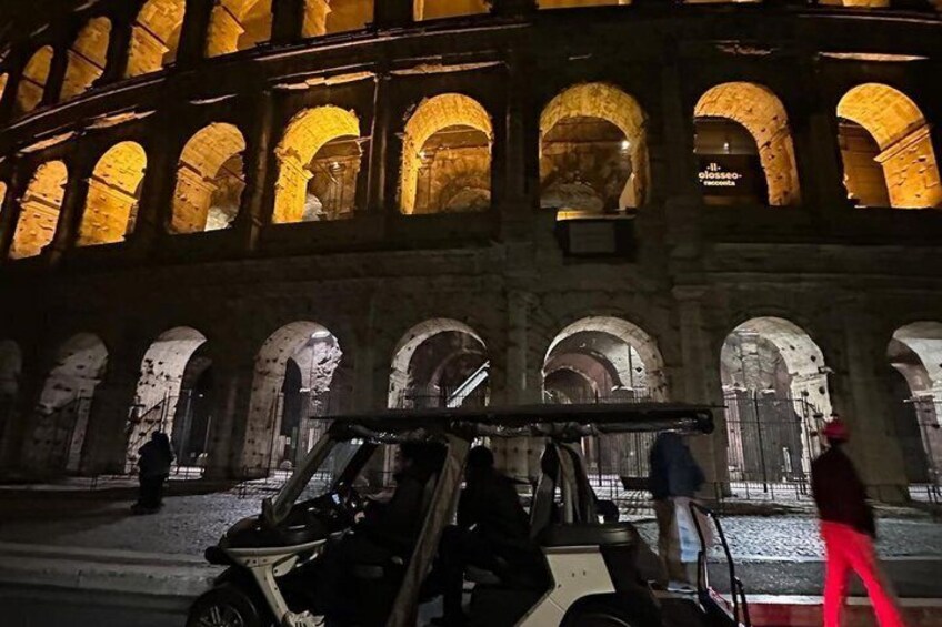A historic building with illuminated arches at night. 4