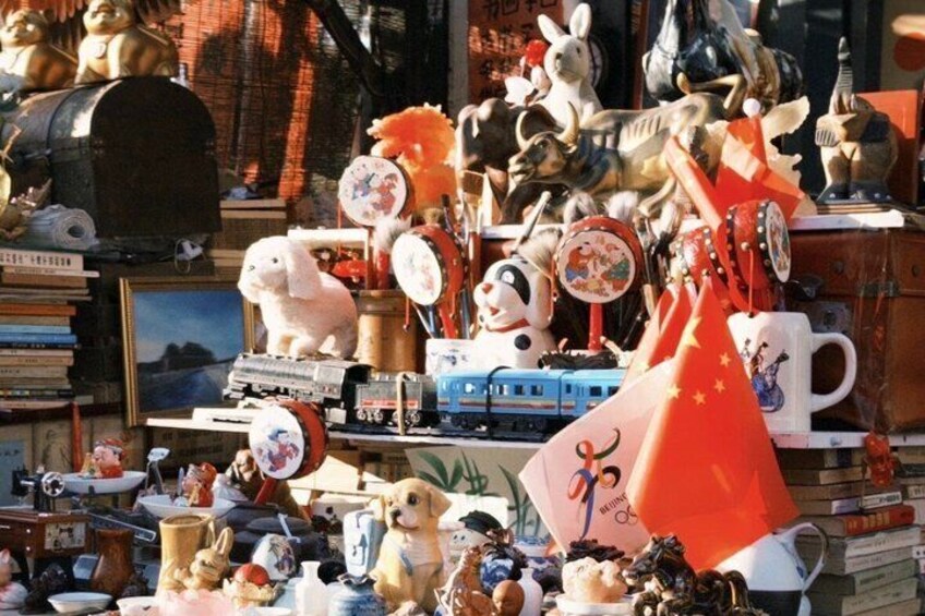 A cluttered display of various items including figurines, toys, and kitchenware. 5