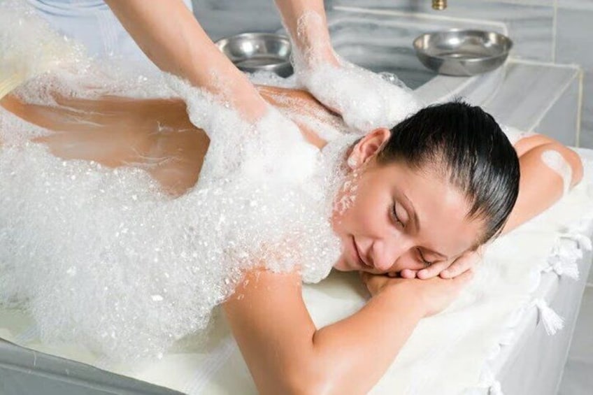 A person receiving a bubble bath treatment. 4