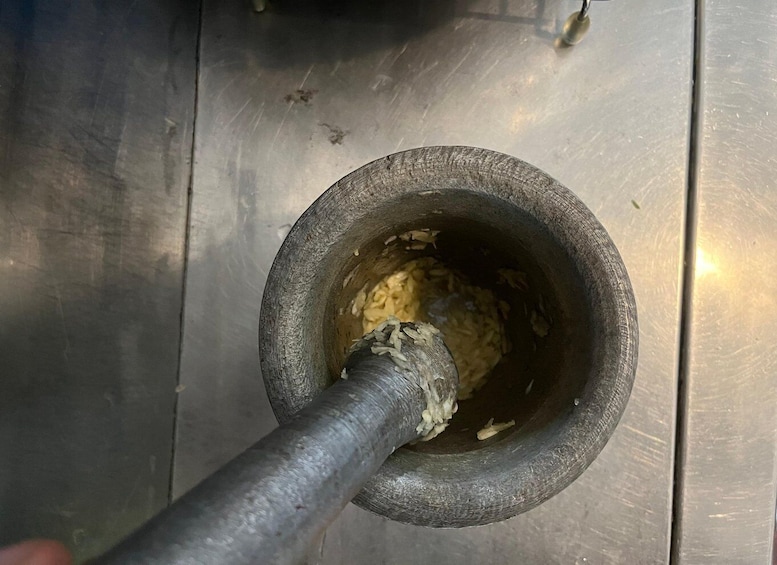 A mortar with a pestle inside, likely used for grinding or pounding. 2
