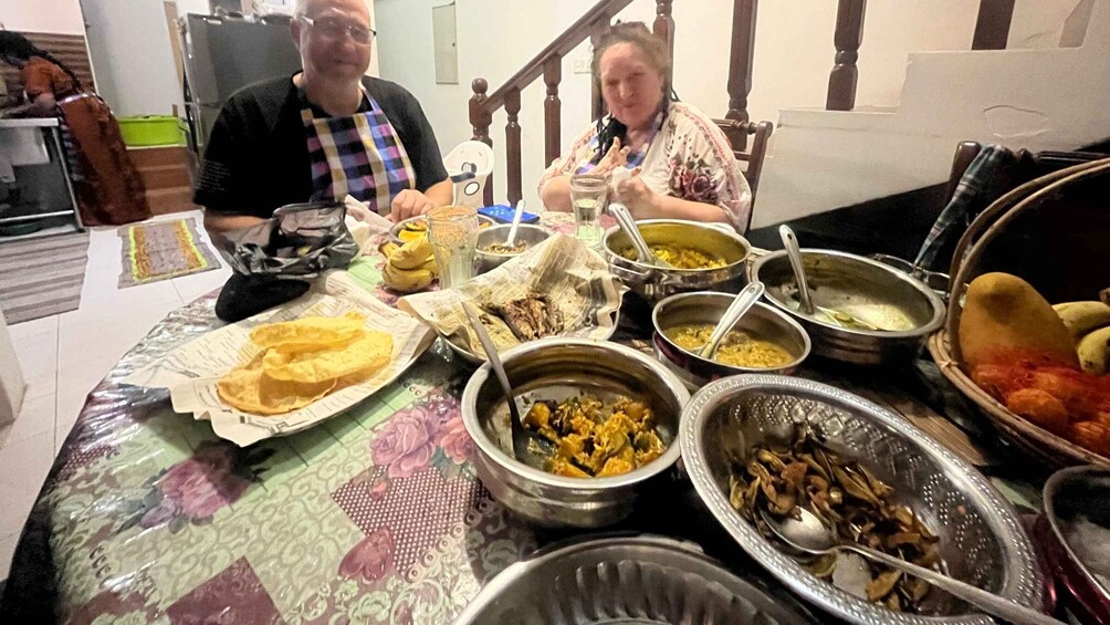 A dining table with various dishes and a person in the background. 2