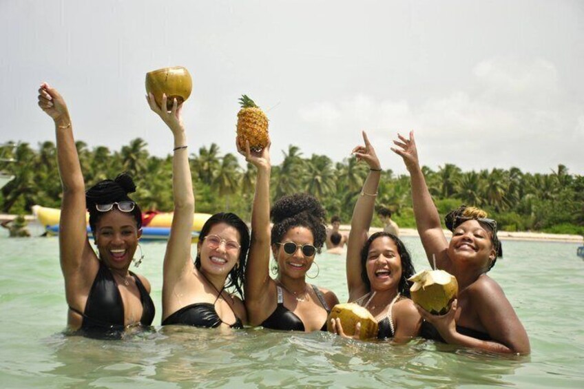 Un grupo de personas en una piscina con palmeras al fondo. 4