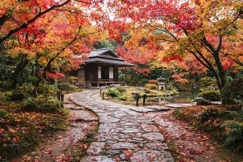 En traditionell japansk trädgård med en stig av stenar, en träbyggnad och ett färgsprakande höstlandskap. 4