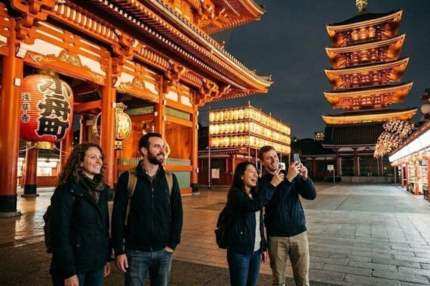 A traditional Japanese temple with illuminated lanterns and pagoda-style architecture. 1