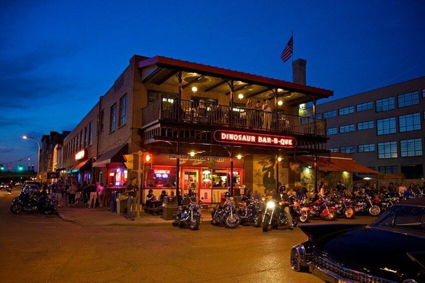 A bar named 'Dinosaur Bar-B-Que' with motorcycles parked in front. 5