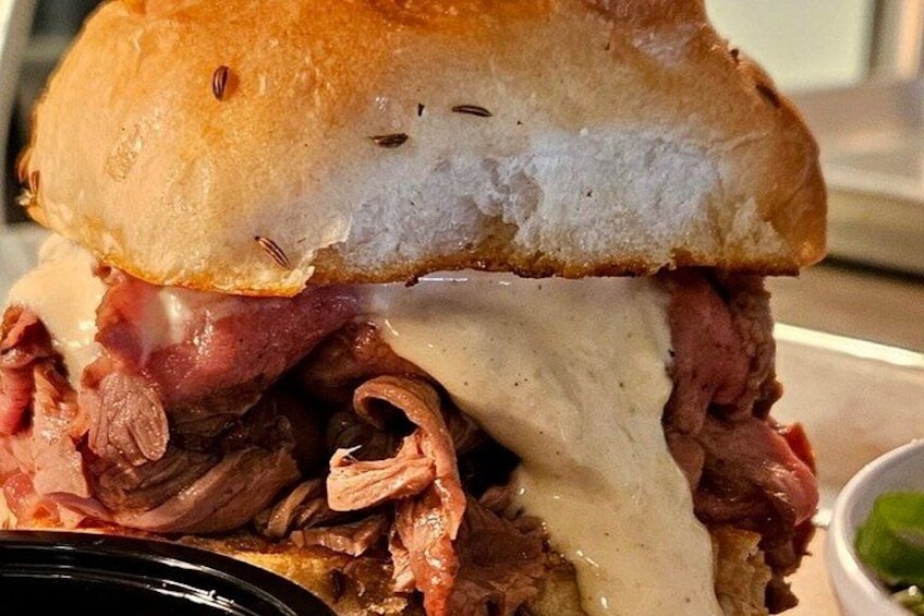 A sandwich with meat and melted cheese. 4