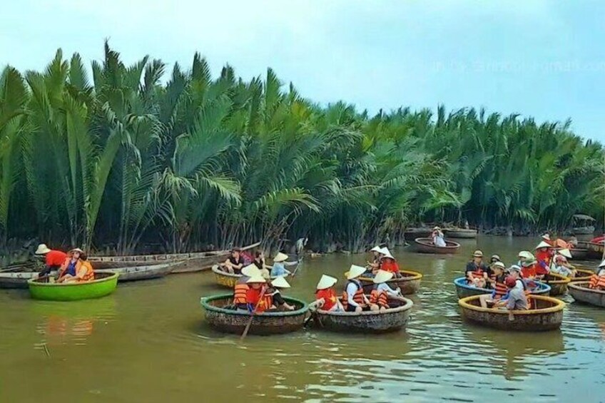People in small boats on a river surrounded by dense palm trees. 5