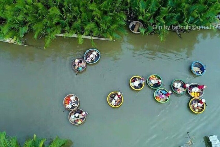 A group of people in small boats on a river surrounded by greenery. 3