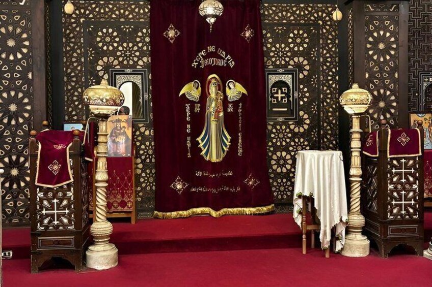 A religious ceremony with a red carpet, ornate columns, and a central altar with a golden cross. 3