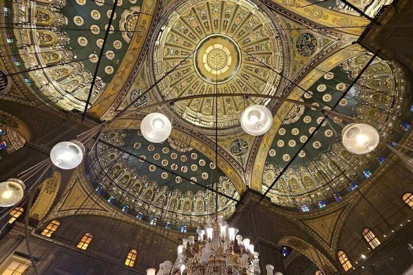 A grand, ornate ceiling with intricate patterns and a central chandelier. 2