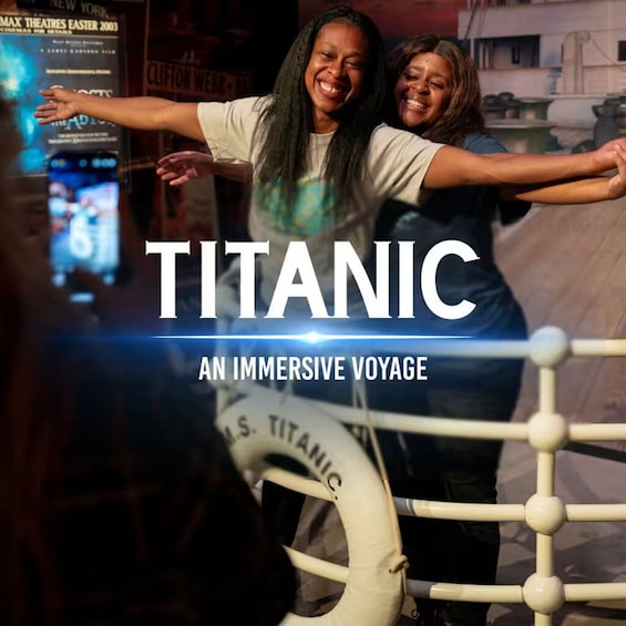A person in a white shirt with a graphic design, standing in front of a life preserver labeled 'U.S. TITANIC' with arms outstretched. 5