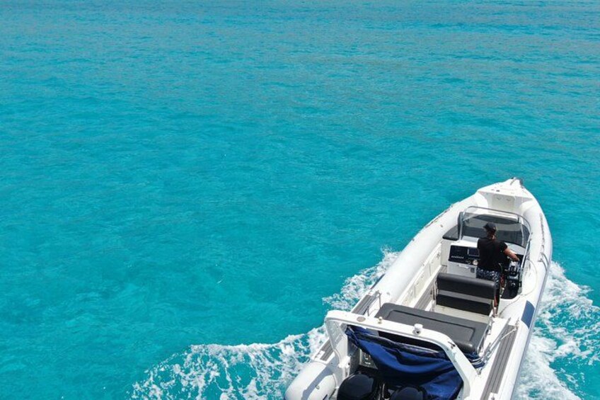 A small white boat on turquoise water. 3