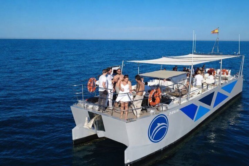 A boat with people on board, a lifebuoy, and a flag. 2