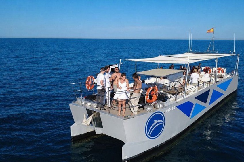 A boat with people on board, lifebuoys, and a flag. 4