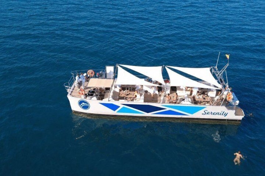 A boat named Serenity on calm blue waters. 3