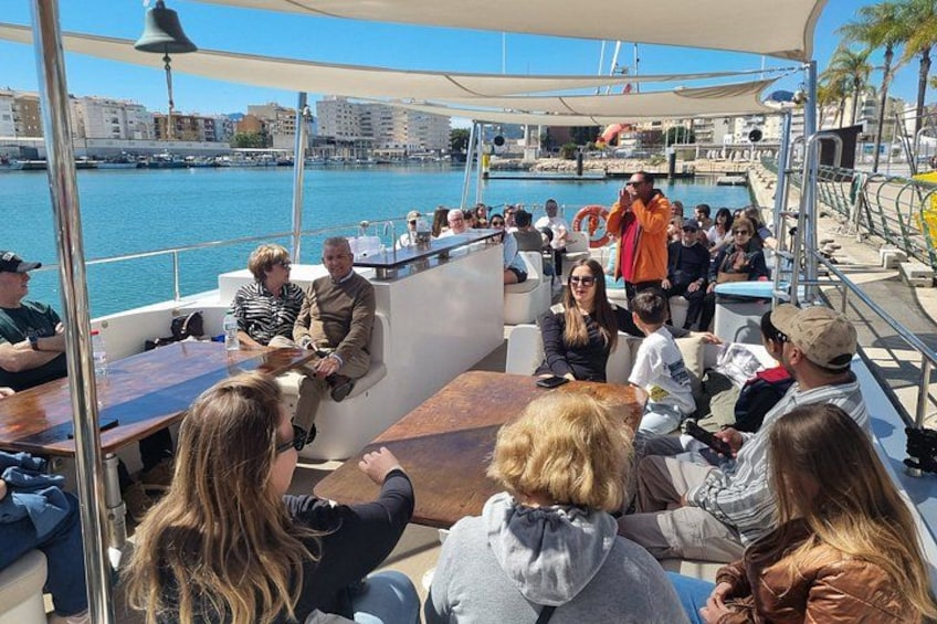 A group of people on a boat with a marina in the background. 5