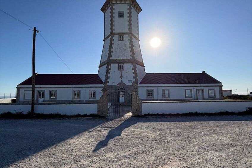 A white building with a red roof and a tower. 4