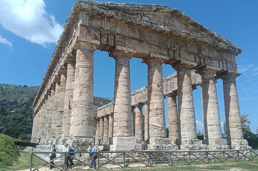 Ancient ruins with columns and a stone structure. 1