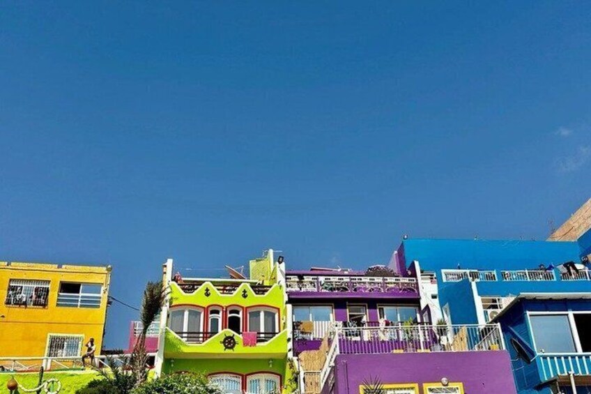 Colorful houses with balconies and a clear blue sky. 5