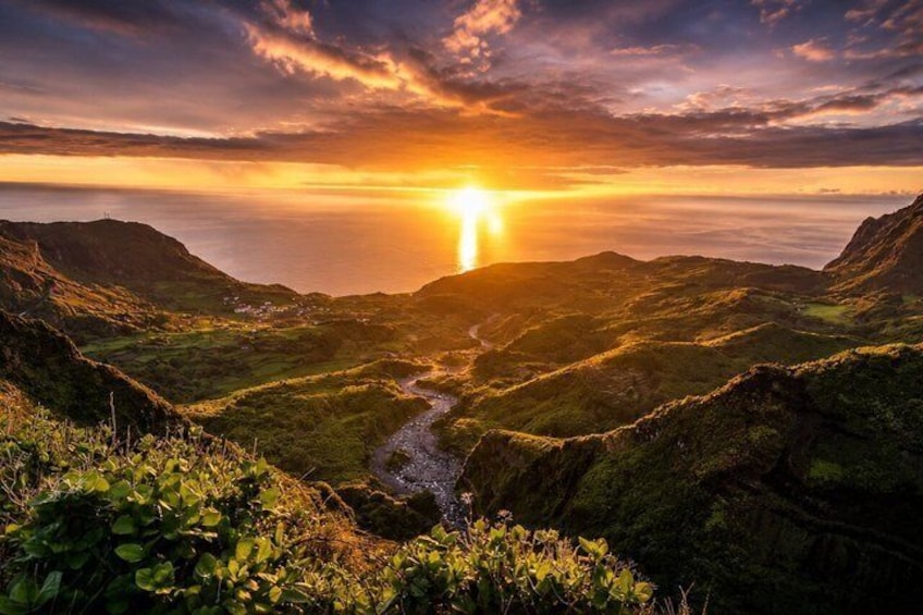 A valley with a river, mountains, and a sunset. 3