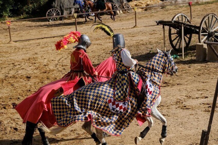A knight in red armor on horseback, a horse with a checkered saddle, and a medieval-style cart in the background. 4